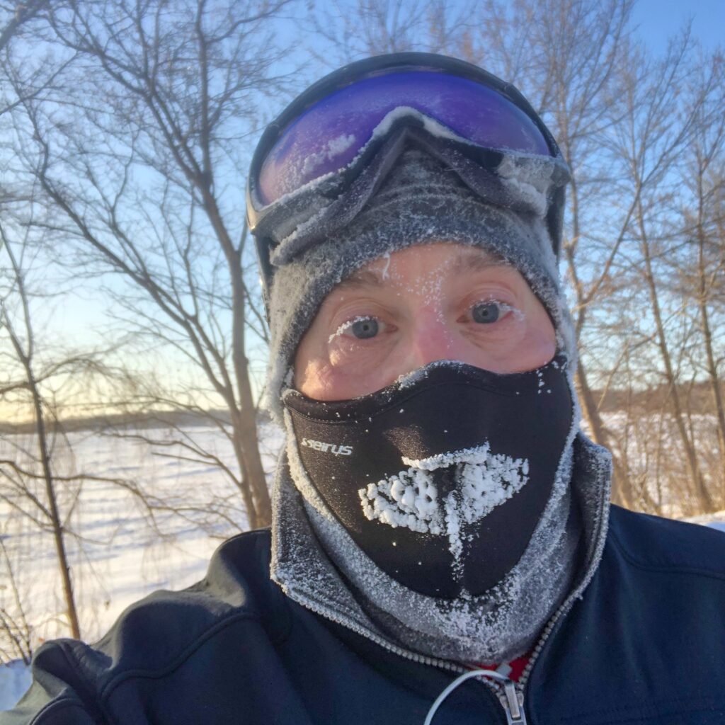 Runner in facemask and goggles.